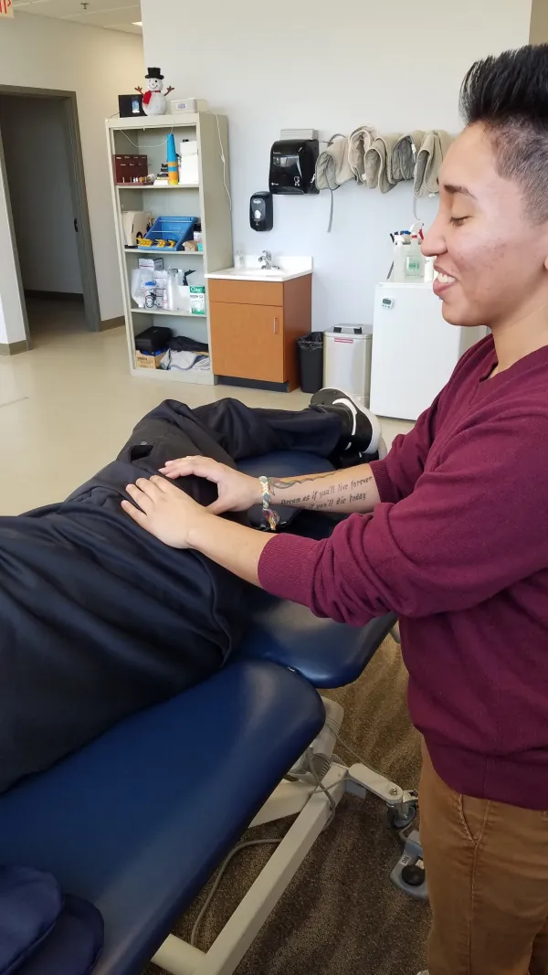 A therapist applying soft tissue work to a patient